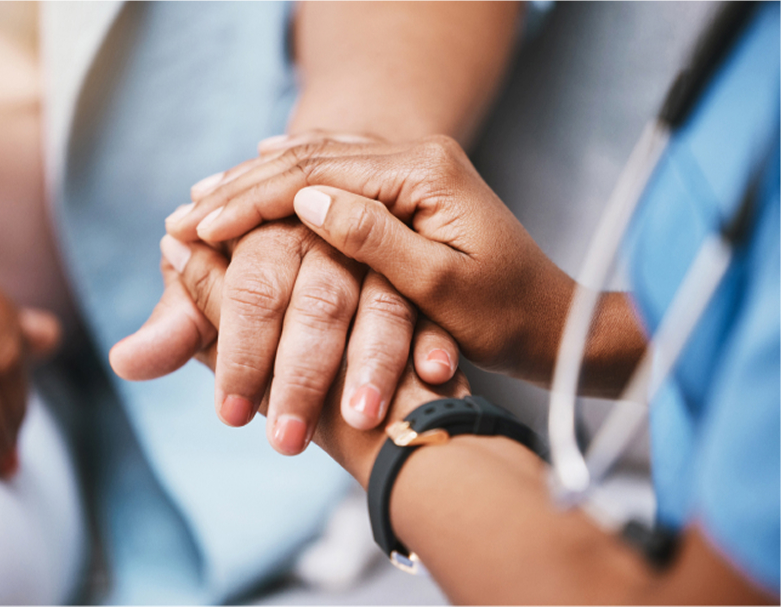 Close-up of a healthcare professional holding a patient's hand, wearing a stethoscope and a smartwatch, symbolizing care and support.